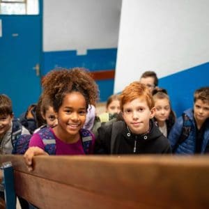 Group of happy smiling multicultural children going together to